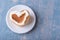 Romantic breakfast in bed. Homemade heart shaped pancake decorated with white cream on a white plate