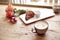 Romantic breakfast, Valentine`s Day celebrating. Present box, rose flowers, fresh croissant, coffee on wooden table. Focus on cup.