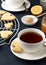 Romantic breakfast on Valentines day with heart shaped cookies and cup of tea on stone background.