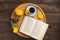 Romantic breakfast. Wooden tray with book, rose, cup of coffee, on wooden background