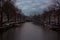 The romantic canals of Amsterdam, the traveling boats and its ancient buildings