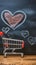 Romantic cart Heart doodles accompany small shopping cart on blackboard backdrop