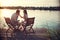 Romantic caucasian couple in love sitting by the river