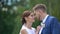 Romantic close-up portrait. The wonderful bride with fantastic smile is tenderly rubbing and kissing the nose of her