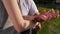 Romantic closeup of a young man s hand holding a young woman s hand when the happy couple is standing in the park near