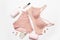 Romantic composition with female pink underwear, candle, lip gloss, perfume and stars decor on a gray background. View from above