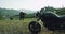 Romantic couple arrived with their black motorcycle in the middle of amazing landscape with green field mountain and