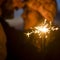 Romantic couple concept celebrating new year eve holiday christmas together with love - closeup of sparklers and people in