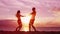 Romantic couple dancing on beach having fun at sunset playful and happy travel