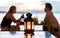 Romantic couple dating dinner blur background under candle light lantern and sunset twilight sky with clouds during beautiful gold