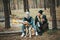 Romantic couple with dog sitting near bonfire, autumn forest background. Young blonde woman and handsome man. Concept - family, to