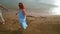 Romantic couple drawing heart on sand. Steady shot of love couple