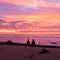 Romantic couple enjoy spectacular beach sunset