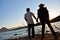 Romantic couple holding hands sunset edge of lake