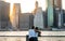 Romantic couple looking to Manhattan skyline from Brooklyn riverside during sunset , New york city