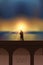 Romantic couple in love on a bridge by the sea at magic sunset