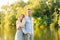 Romantic couple in love guy and girl in the summer in the Park on the background of the lake. Newly married couple. The girl hugs