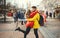 Romantic couple in love kissing, hugging, walking on the street, wearning in bright down jackets. urban background.