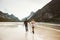 Romantic Couple in love walking holding hands on sea beach in Norway