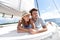 Romantic couple lying on deck of sailing boat