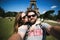 Romantic couple making selfie in front of Eiffel