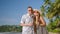 Romantic couple man, woman in tropical travel look at camera with bottles of smoothie stand on sunny sea beach, clink