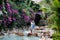 Romantic couple. Multiethnic couple at the swimming pool. Swimming pool surrounded by pink bougainvillea flowers