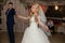 Romantic couple of newlyweds first elegant dance at wedding reception hall