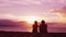 Romantic couple relaxing enjoying on beach looking at sunset