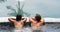 Romantic couple relaxing together in hot tub whirlpool jacuzzi luxury resort