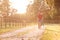 Romantic Couple Riding Bike Along Country Lane At Sunset