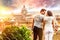 Romantic couple in Rome, Italy. A men and a women, they are looking at each other. On a terrace with railing overlooking Rome at