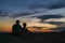 Romantic couple silhouetted against a beautiful night sky on mountain top