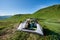 Romantic couple sits in tent overlooking mountain lake amidst scenery mountains