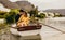 Romantic couple sitting in a boat touching their heads. Couple on a boat date in a lake with hills and houses in the background