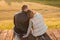 Romantic Couple sitting on the pier in autumn nature.