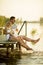 Romantic couple sitting on the wooden pier on the lake