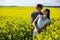 Romantic couple standing in mustard field