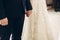 Romantic couple, stylish bride and handsome groom holding hands in church during wedding ceremony in catholic chapel close-up,