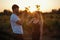 Romantic Couple at Sunset. Two people in love at sunset or sunrise. Man and woman on field