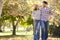 Romantic Couple Walking Through Autumn Woodland