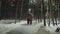 Romantic couple walking in rain in snowy park