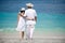 Romantic couple wearing hats on the beach