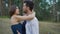 Romantic couple of young people are embracing a clearing in the summer forest.