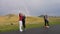 Romantic couples in love enjoying trip taking selfies with smartphone kissing with idyllic amazing rainbow in background -