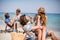 Romantic couples sitting on deck chairs at beach