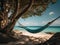 Romantic cozy hammock in the shade of a palm tree on a tropical beach by the sea