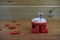 Romantic cup cake in red and white with a miniature person figurine holding a sign board on top and red love hearts