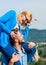 Romantic date concept. Man carries girlfriend on shoulders, sky background. Couple in love walking outdoor sunny day