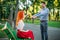 Romantic date of couple on a bench in summer park